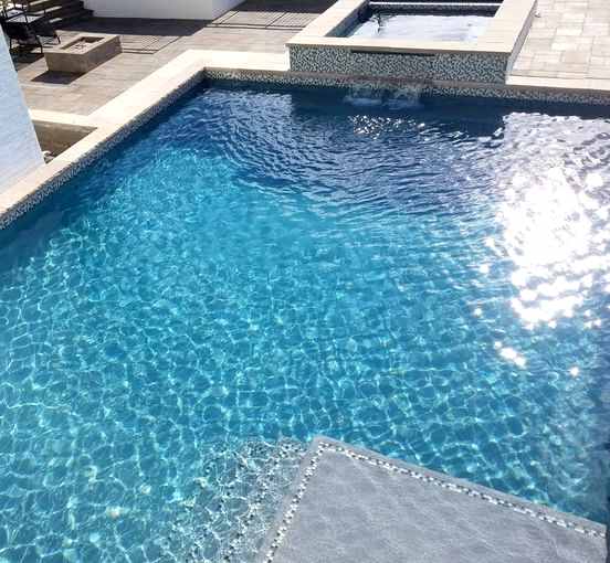 Kid with Broncos hat enjoying pool